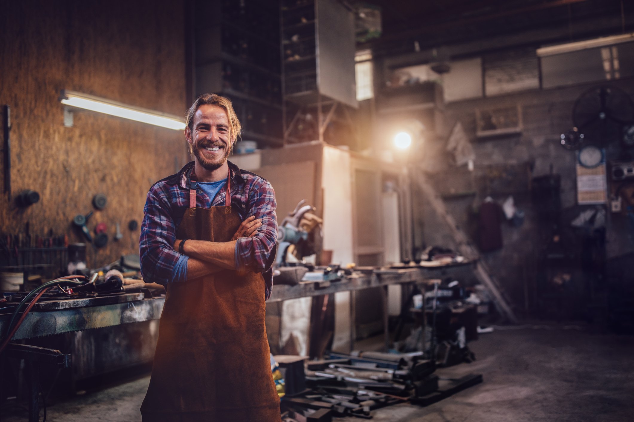 Person standing in an industrial machine shop.