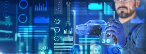 An electric car design concept featuring a worker operating a digital display.