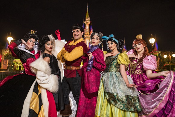 Actors dressed as Disney villains in front of the Magic Kingdom.