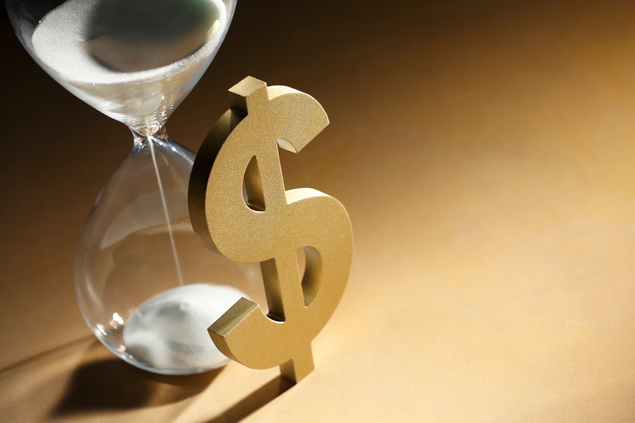 Hourglass next to dollar sign