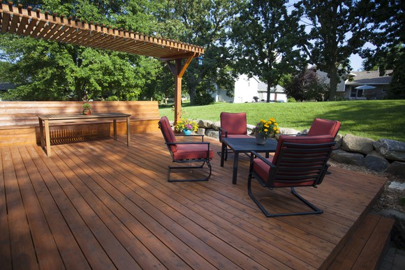 A large deck at the back of a house.