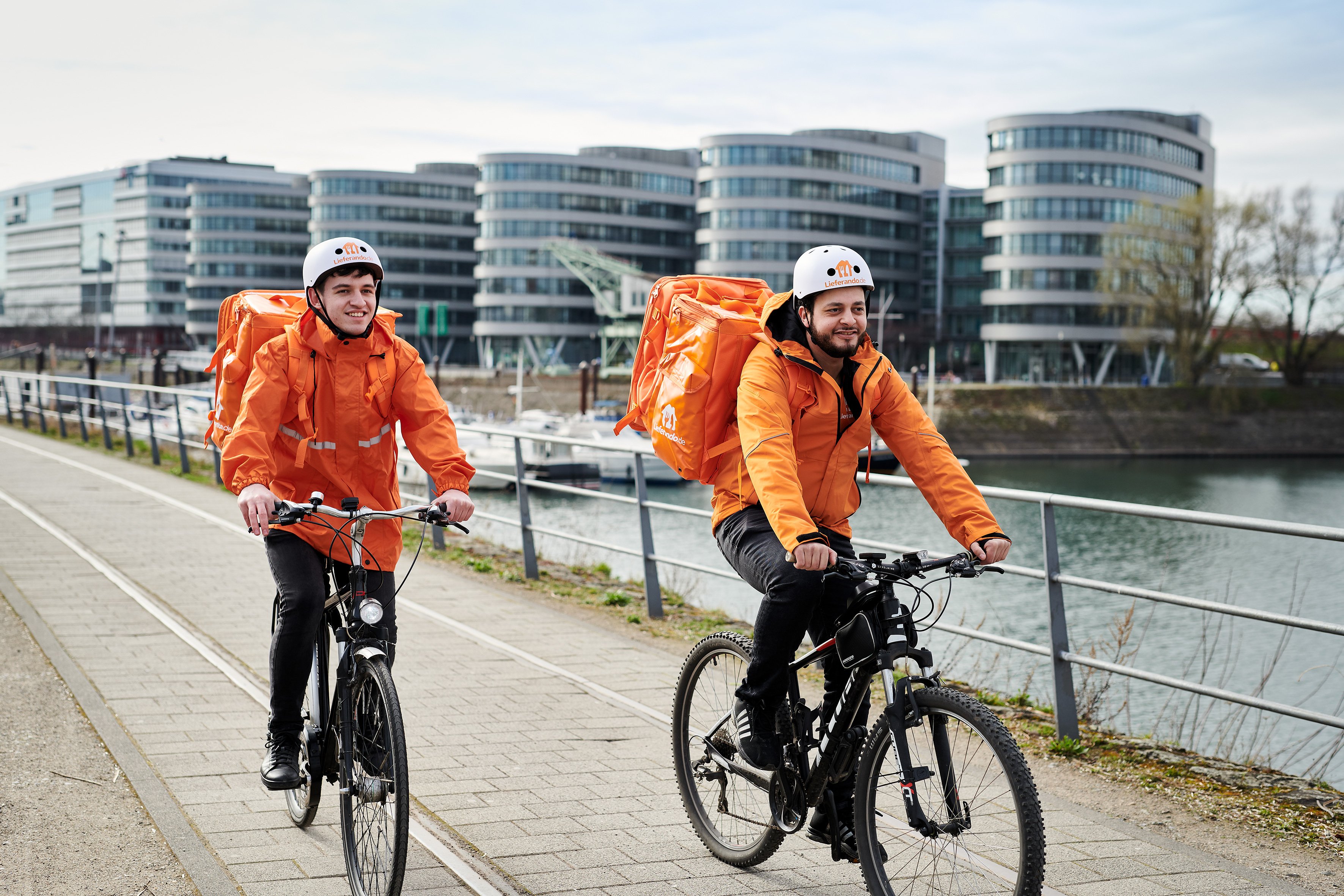 Couriers for Just Eat Takeaway food delivery service ride their bikes