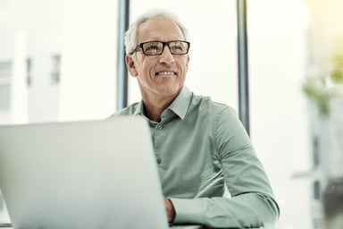 Smiling person at laptop_GettyImages-539459082