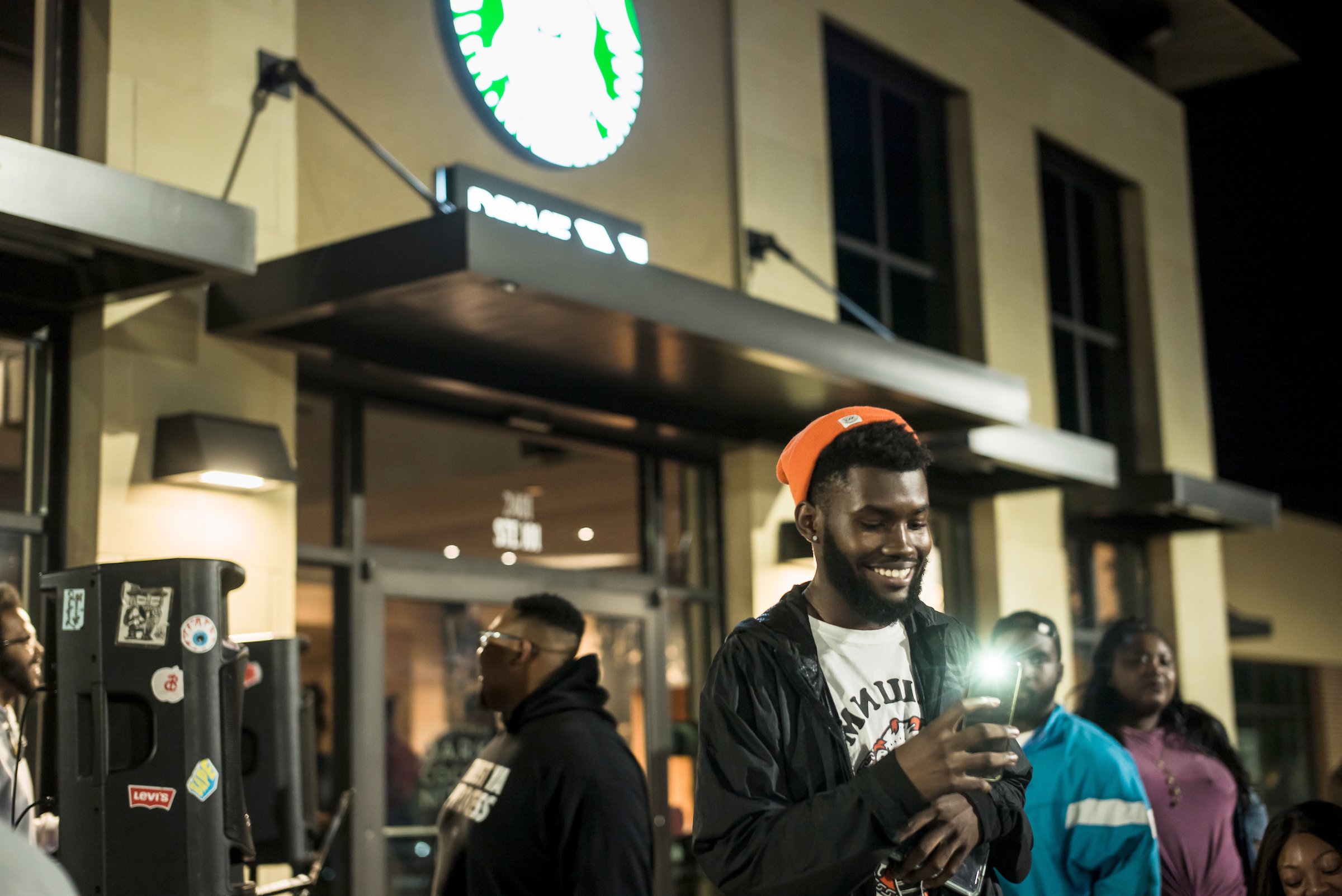 A customer standing in front of a Starbucks store.