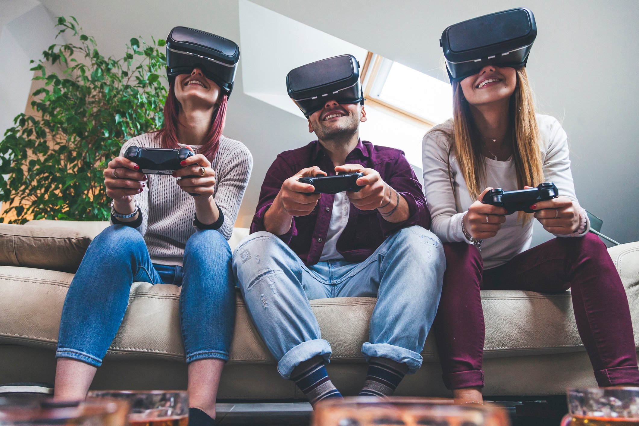 Three friends gaming with VR headsets.