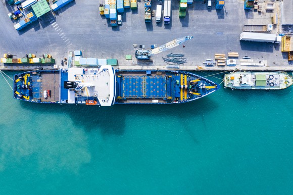An aerial view shows a cargo ship being unloaded while in port