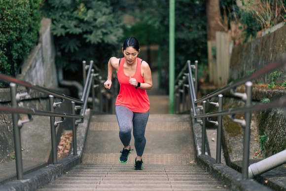 Person running up a staircase as exercise.