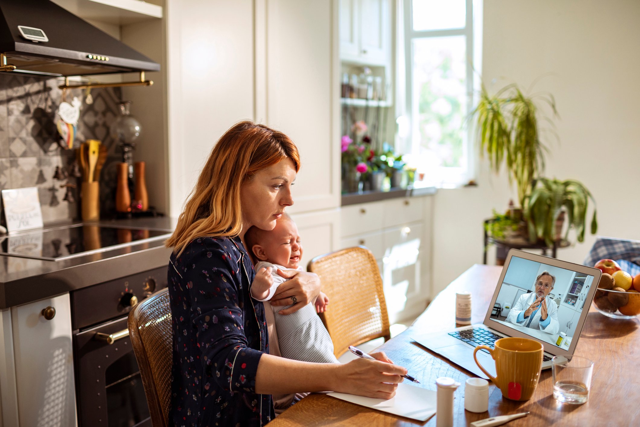 Woman with child on video call with doctor