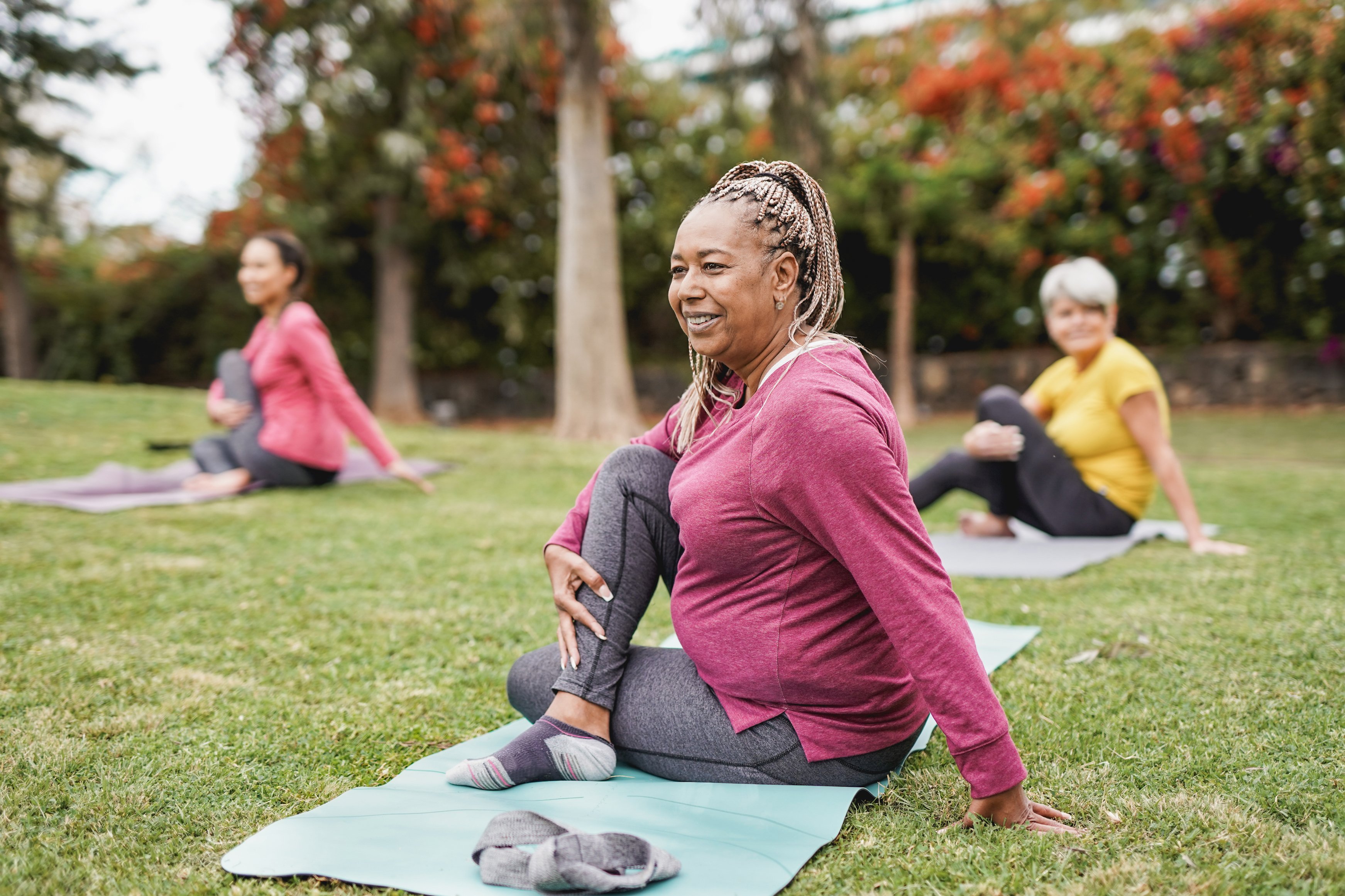 A group of people exercising outside.