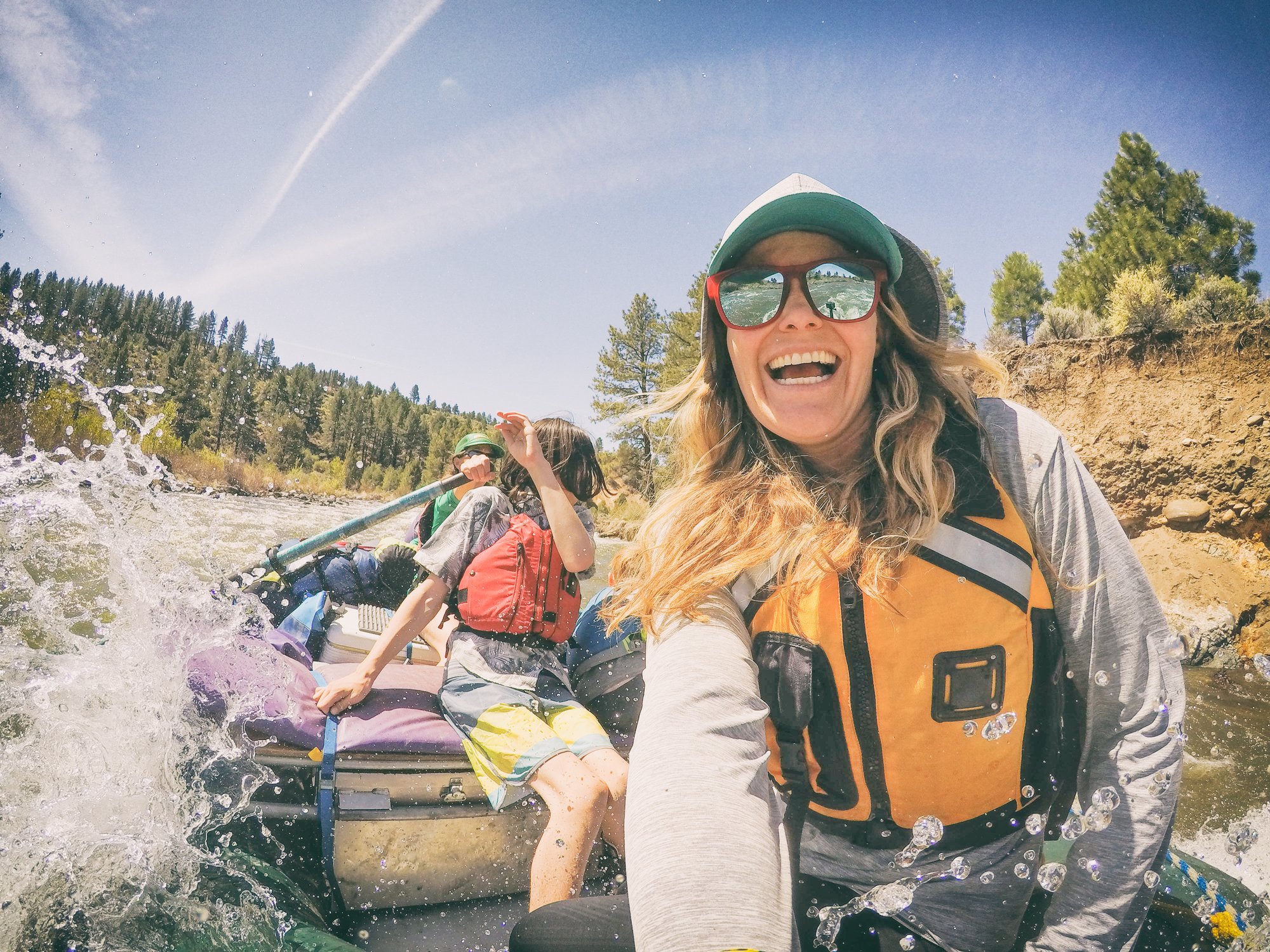 A family whitewater rafting down a river.