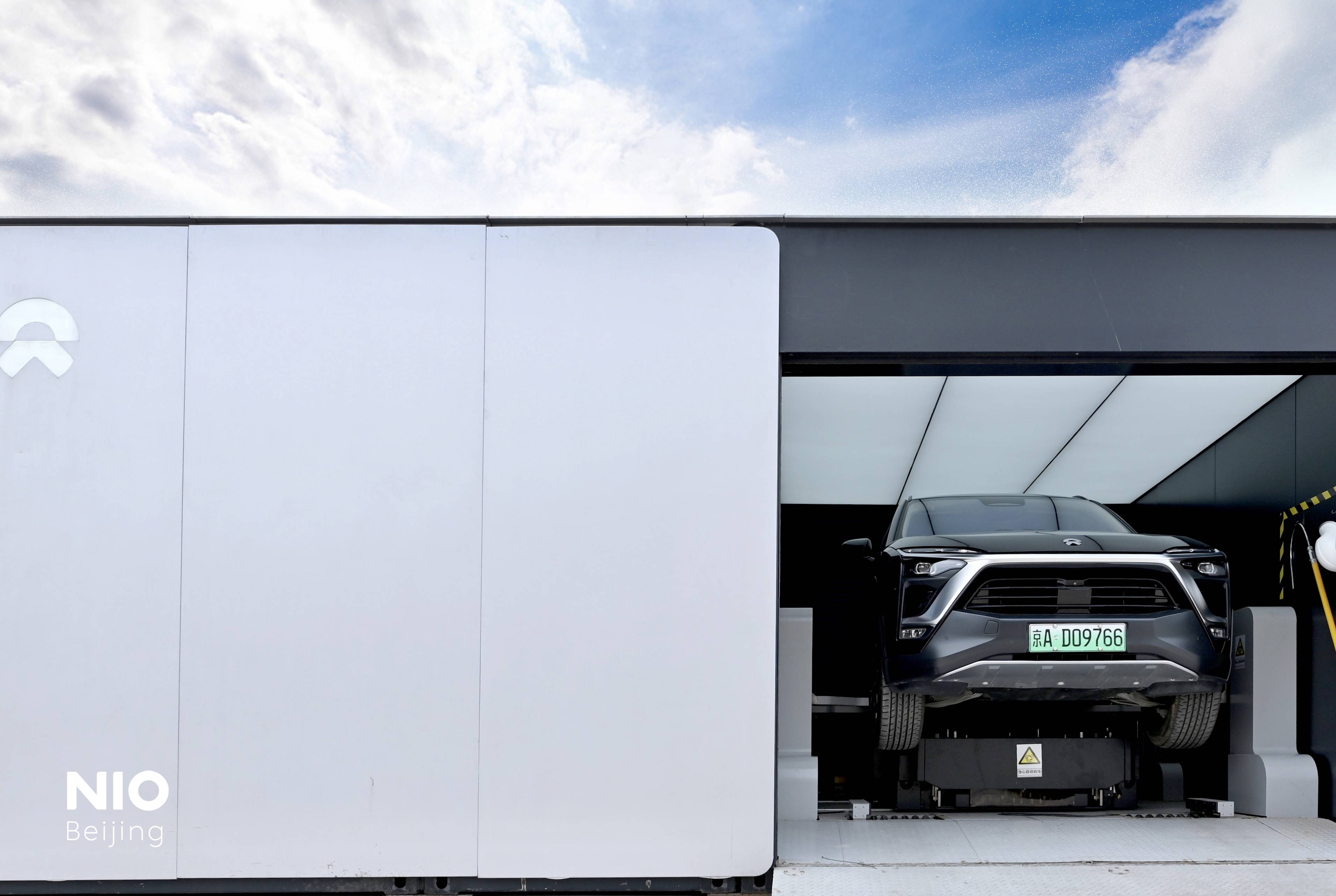 Nio vehicle inside a custom charging station.