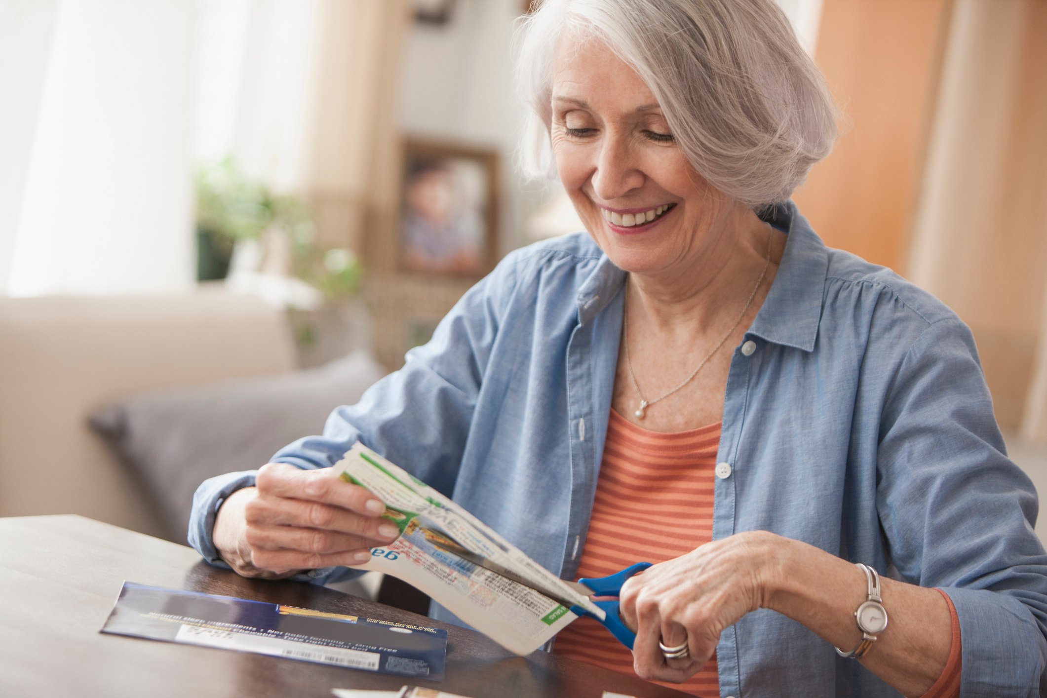 A person clipping coupons.