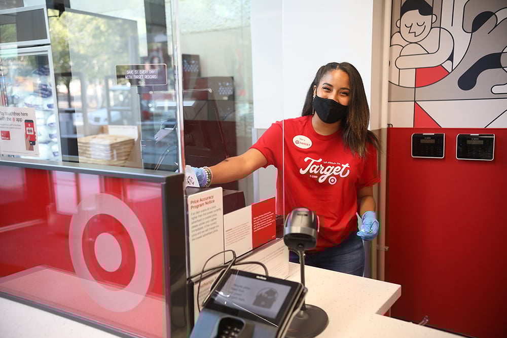 A Target employee working at a checkout counter.