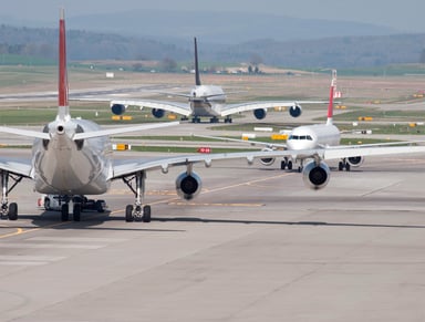jets sitting on runway tarmac