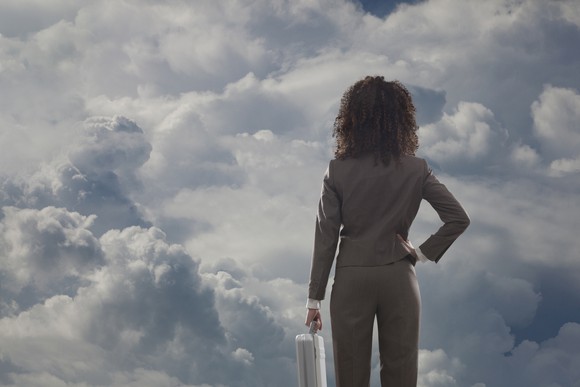 Person looking at cloud-filled sky.