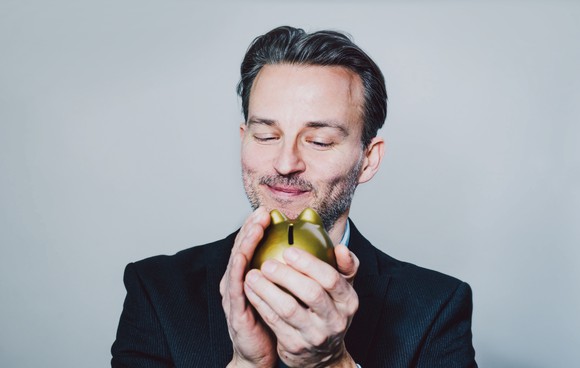 Person holding a piggy bank.