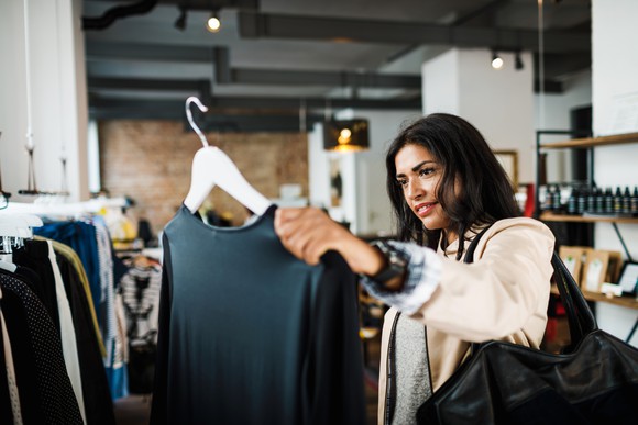 A customer browsing clothes in a store.
