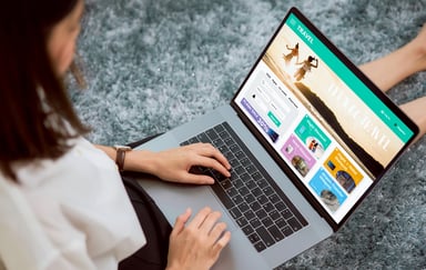 Woman looking at a travel website on a laptop