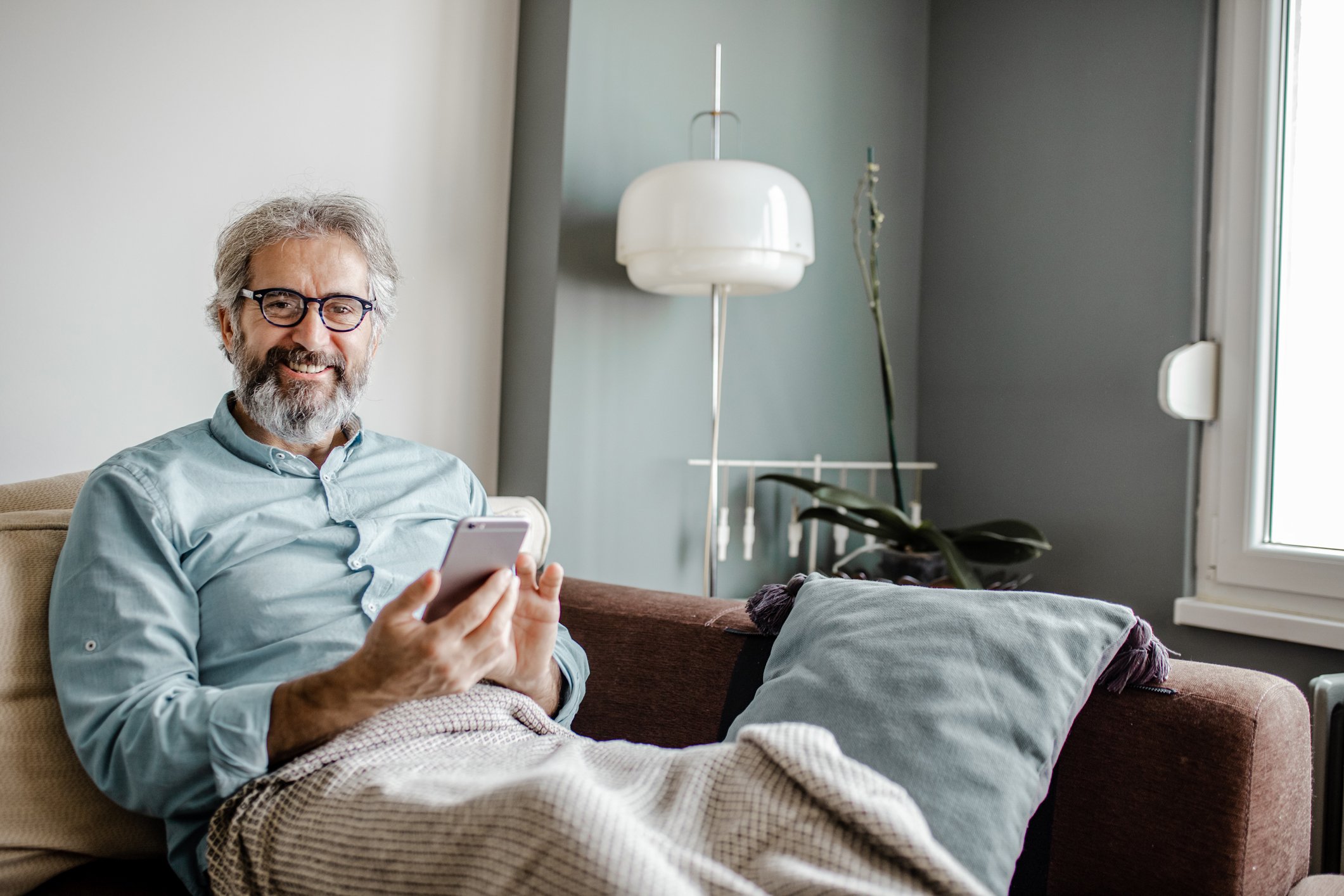 Person smiling while using their phone.