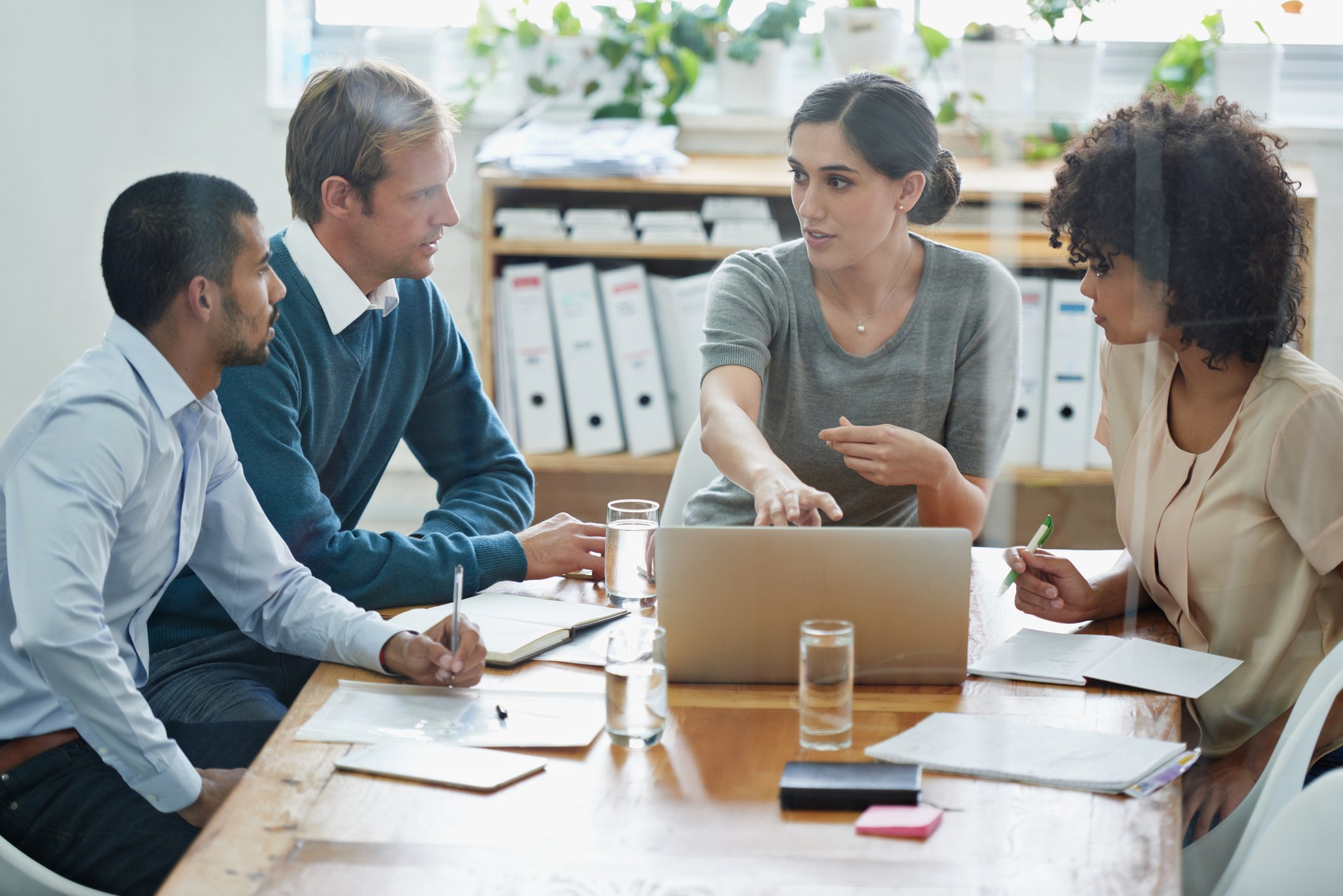 People at a conference table in an office.