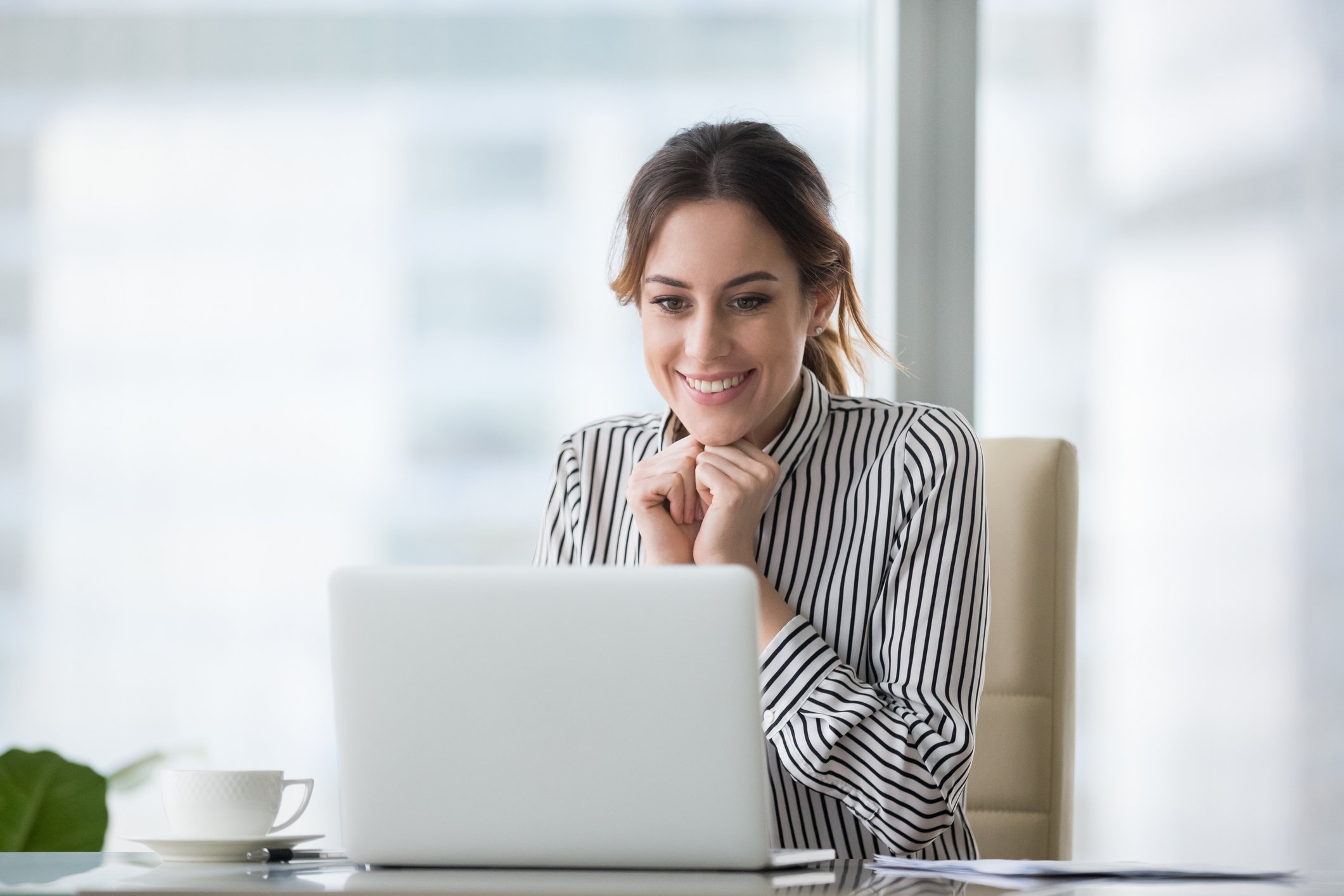 Excited person looking at their computer.