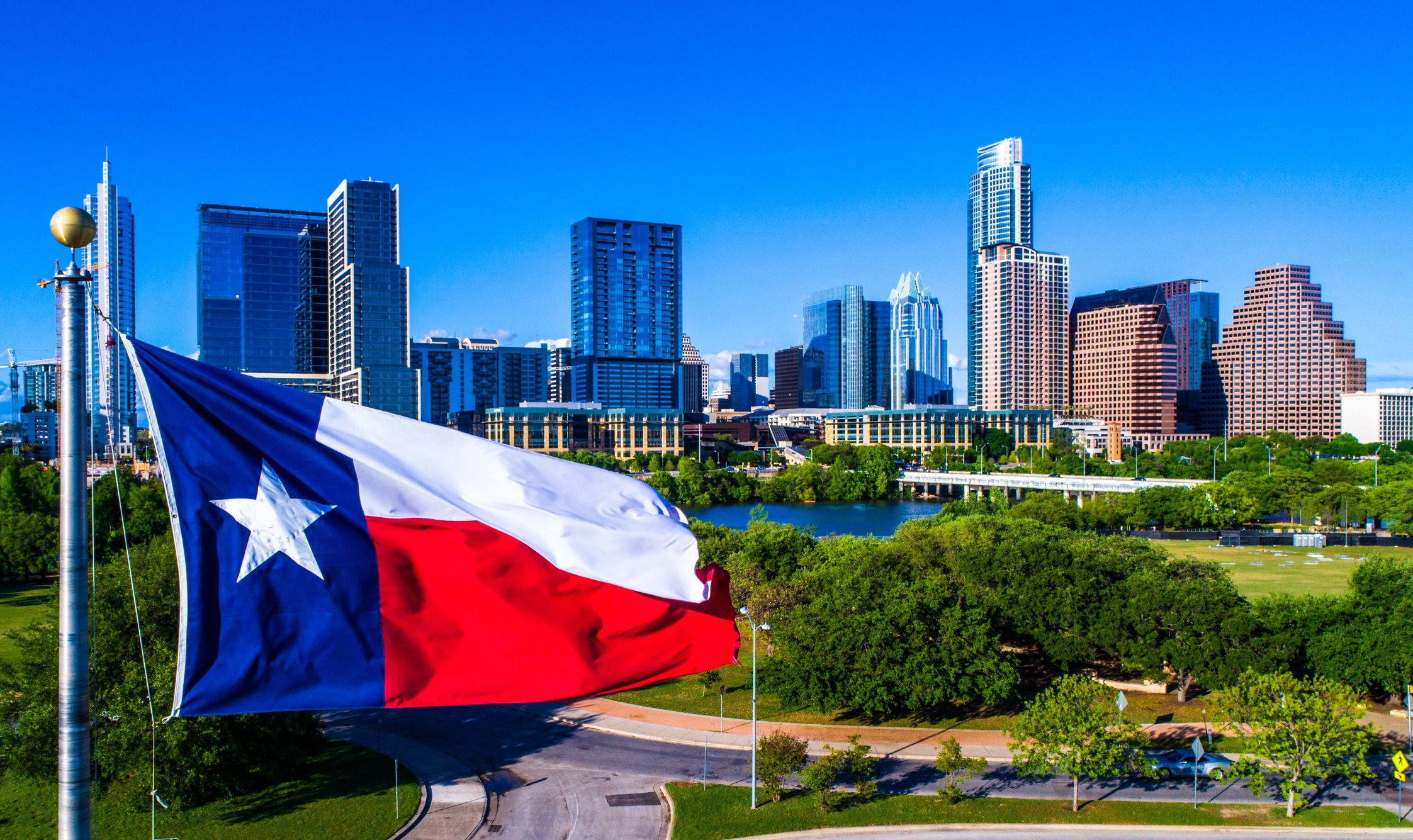 Austin skyline with Texas flag in foreground.