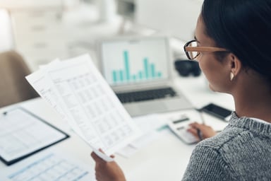 A businesswoman reviewing paperwork in her office