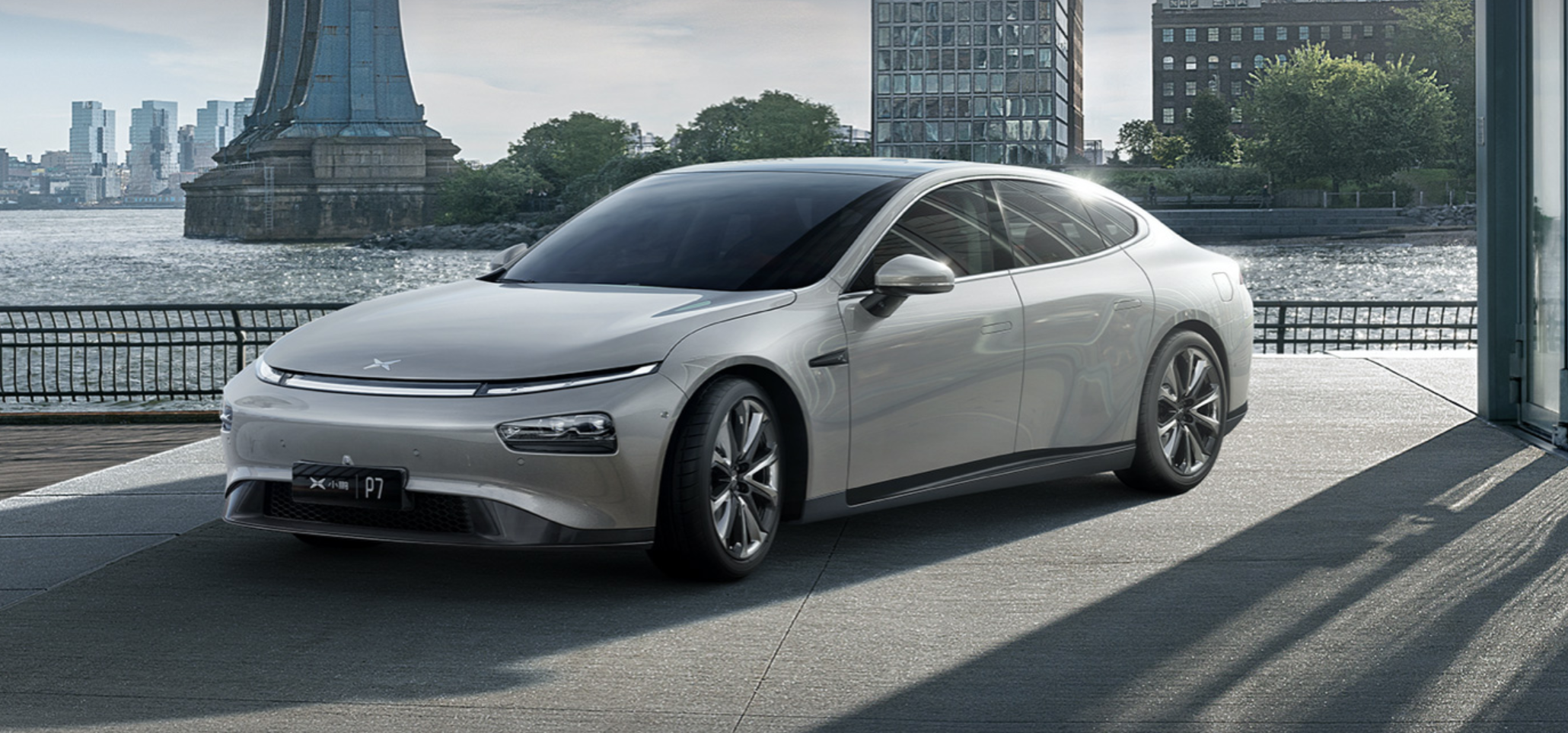 Grey XPeng P7 electric sedan on display outdoors. 