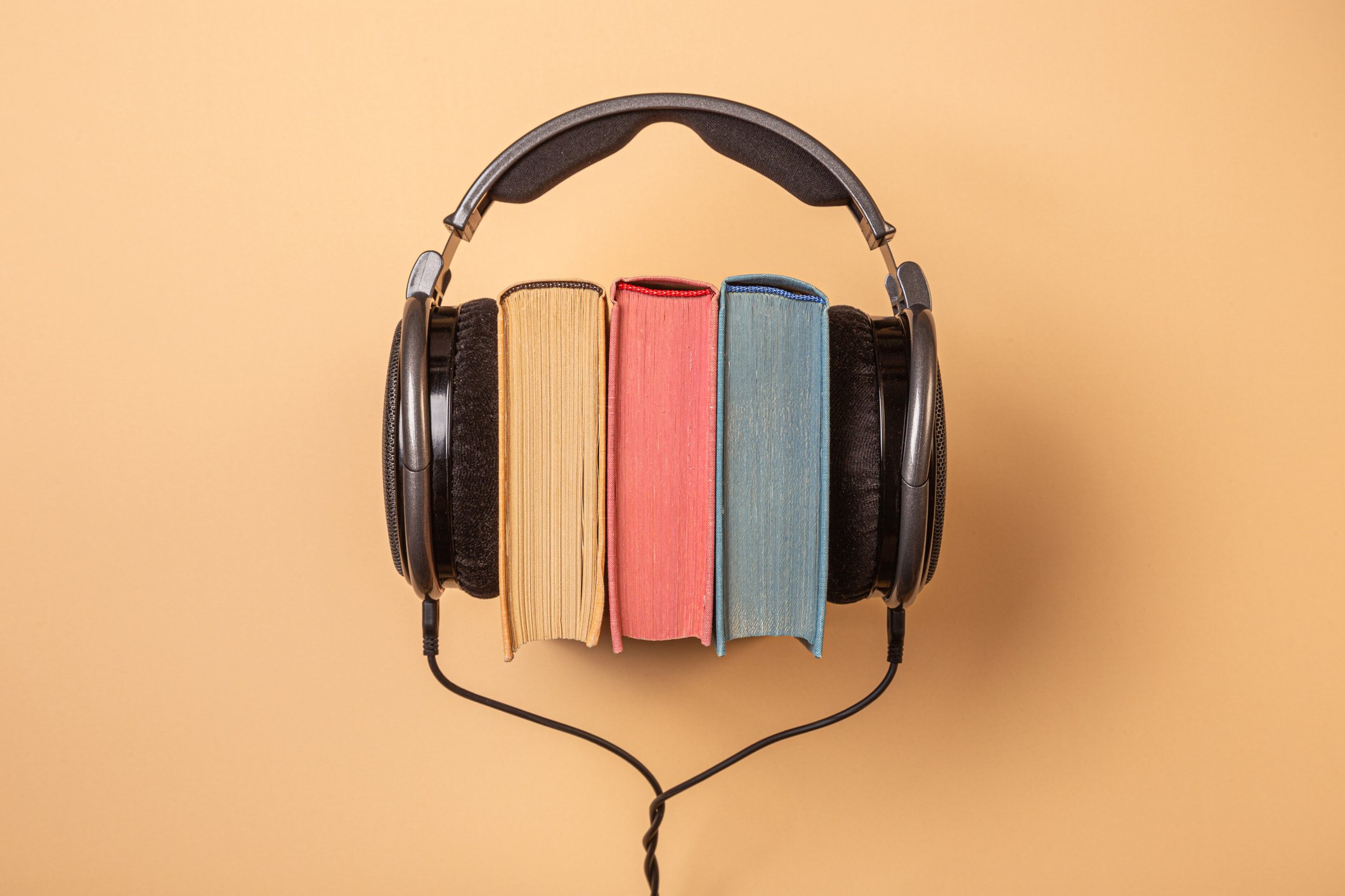 Headphones on a stack of books.