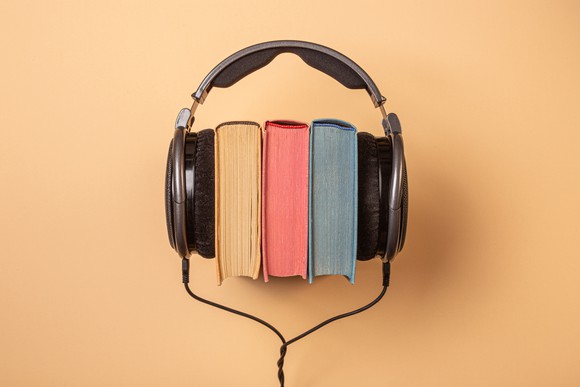 Headphones on a stack of books.
