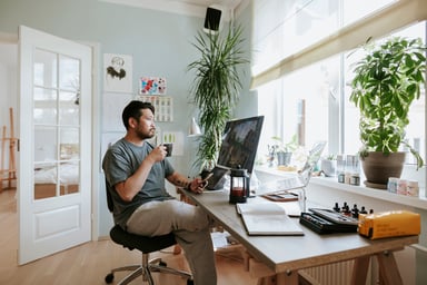 Man Drinking Coffee While Working
