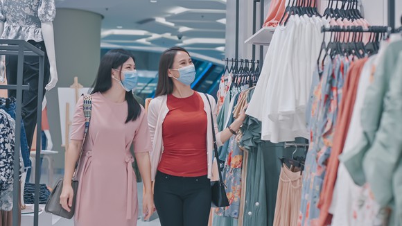 Two people shopping in a store.