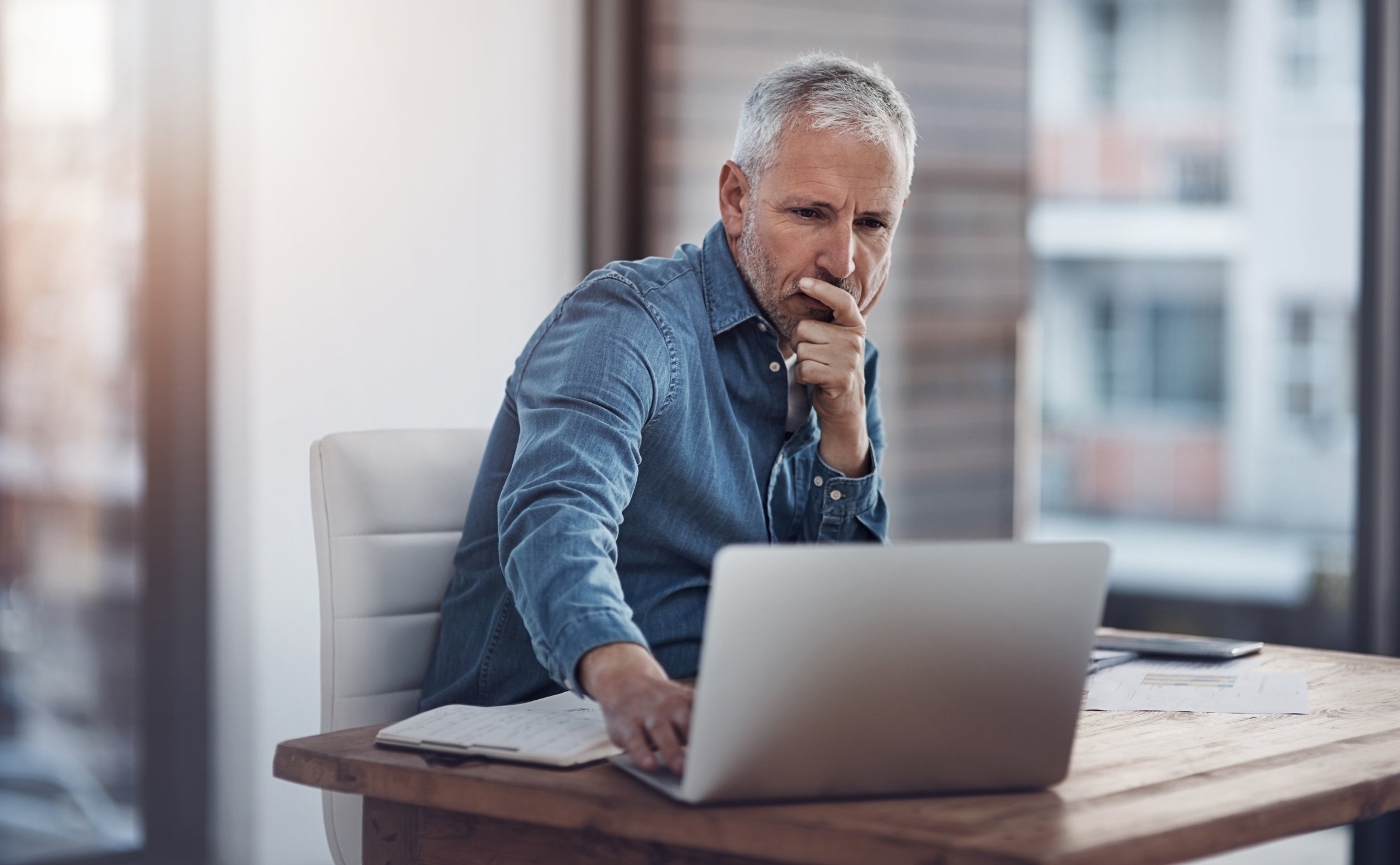 A business person studying something on a computer.