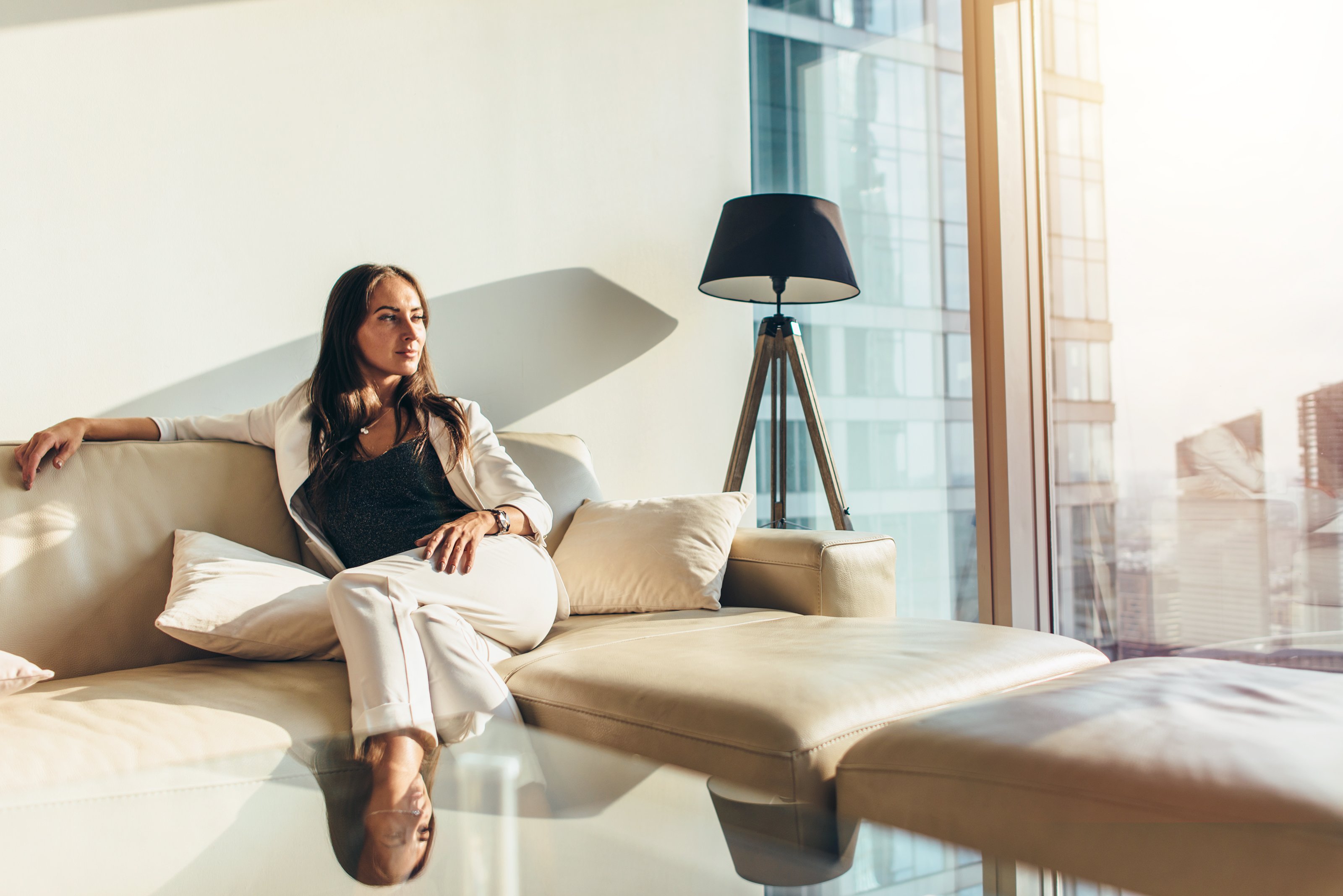 A person sitting on a leather sofa.