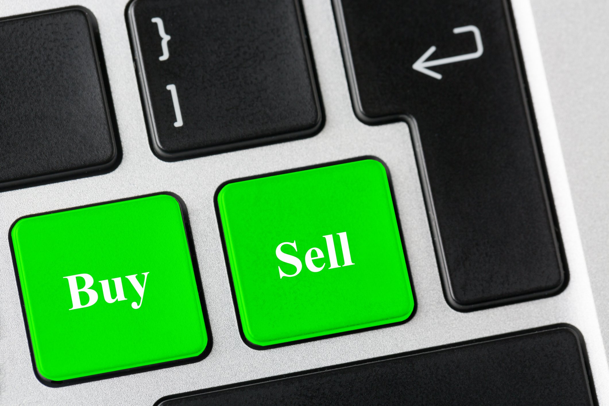 Keyboard buttons labeled buy and sell. 