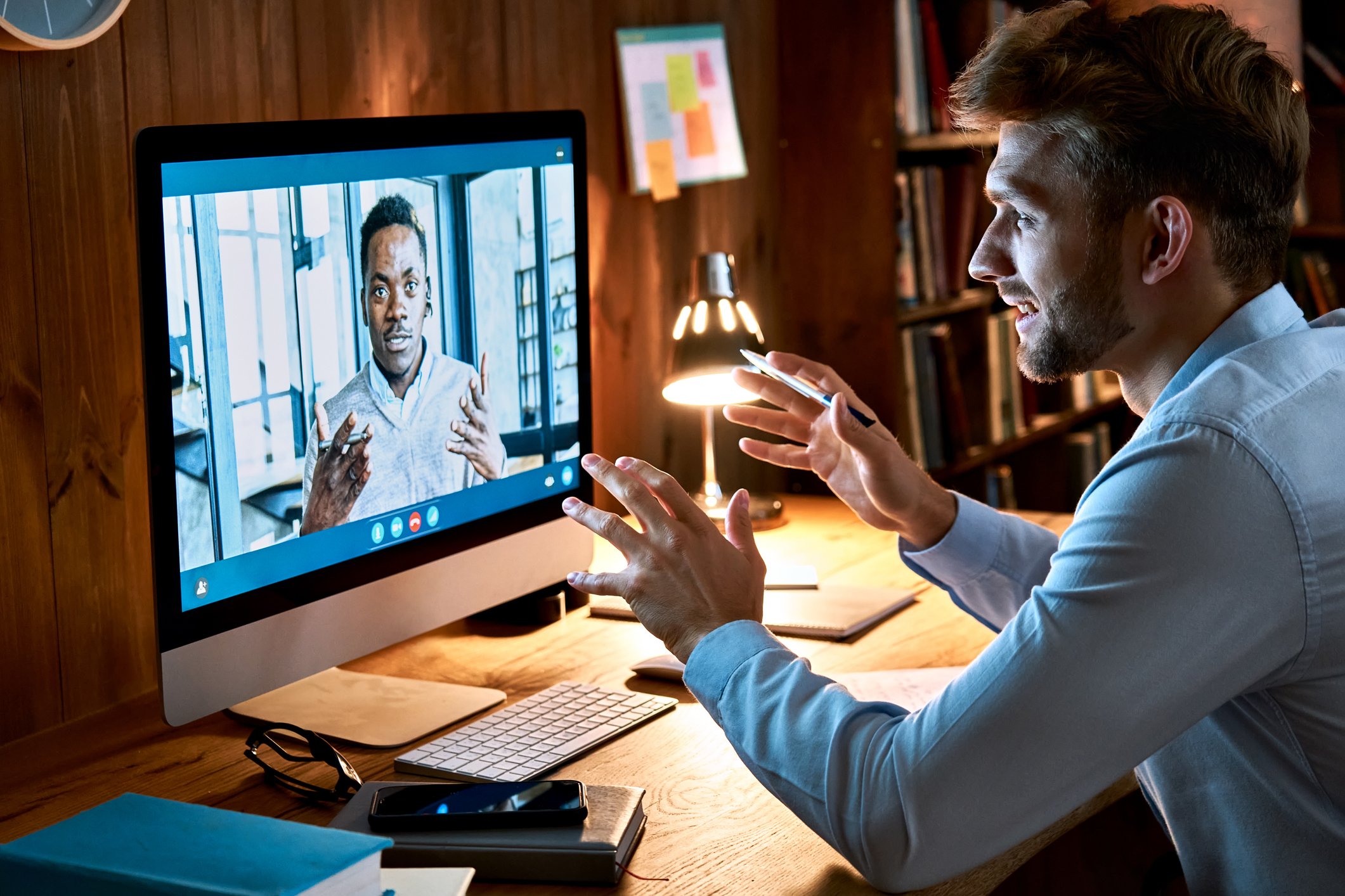 Two people on a virtual video meeting.