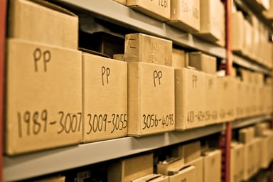 Archived boxes sit in storage
