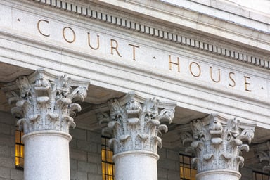 Gray masonry facade reads COURT HOUSE.