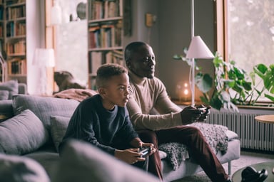 parent and son playing video games