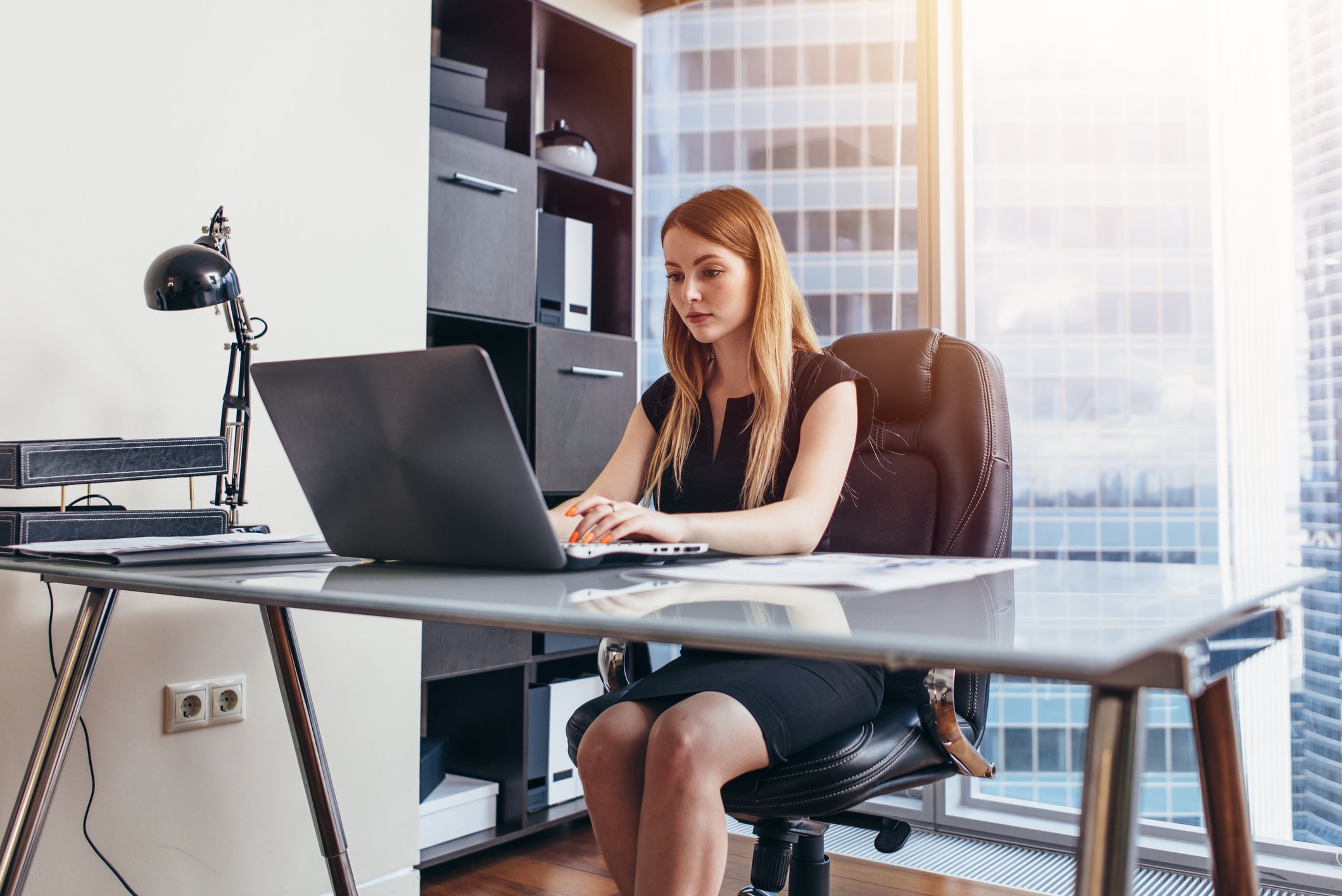A person at a desk in a corporate office.