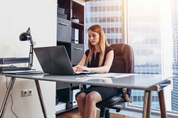 A person at a desk in a corporate office.