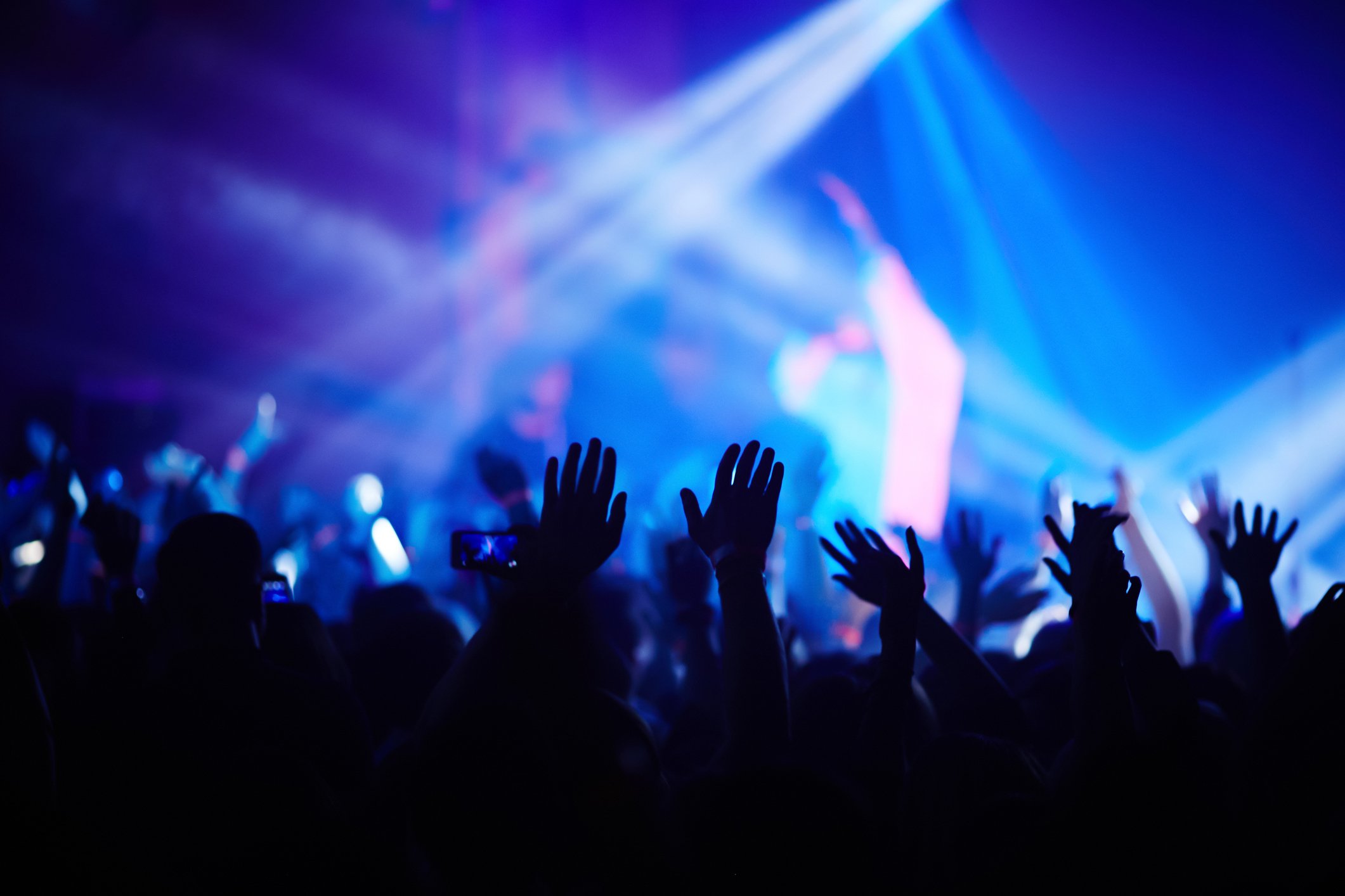 Hands being raised at a concert.