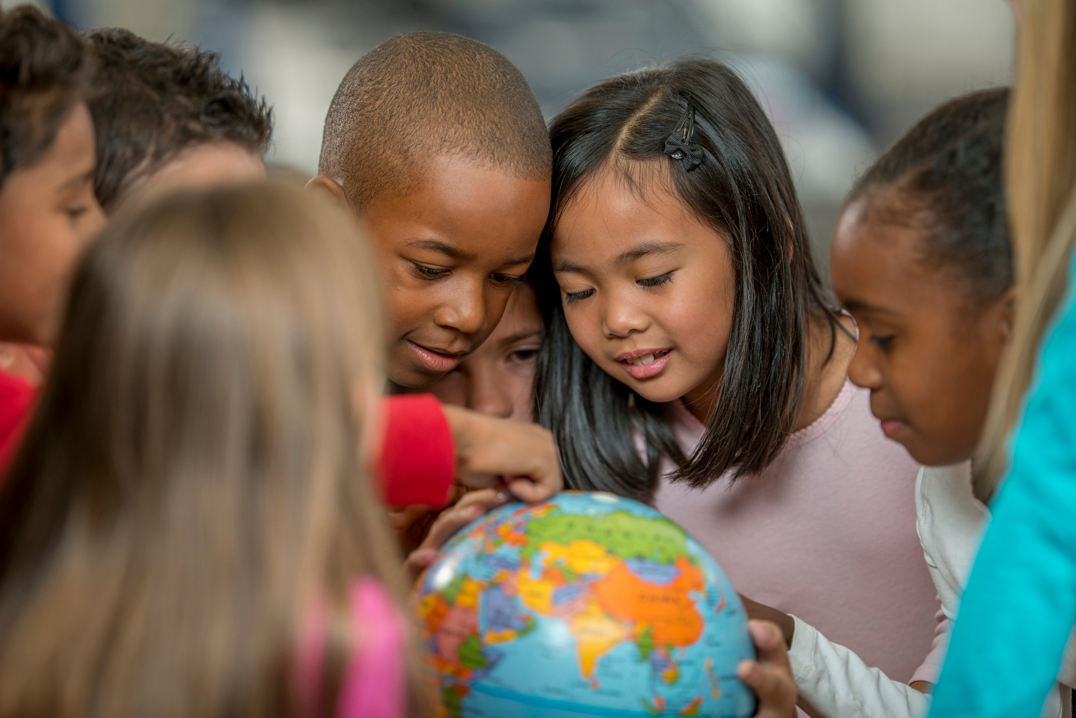 Children looking at a globe.