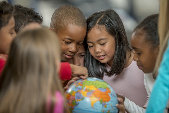 Children looking at a globe.