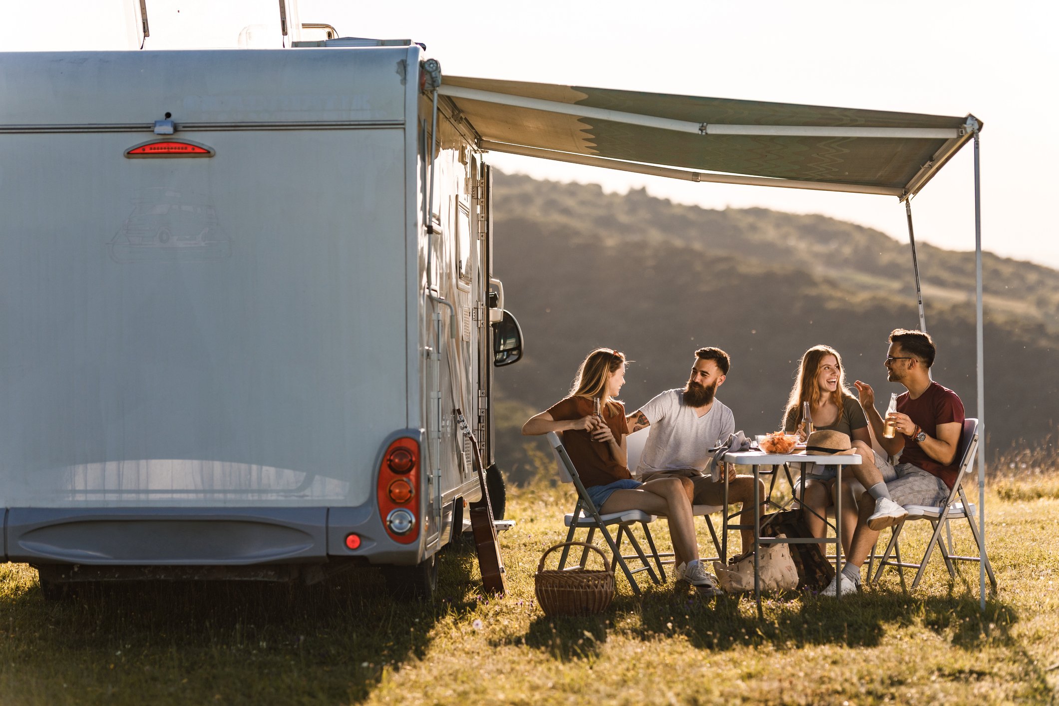 A group of friends camping with an RV.