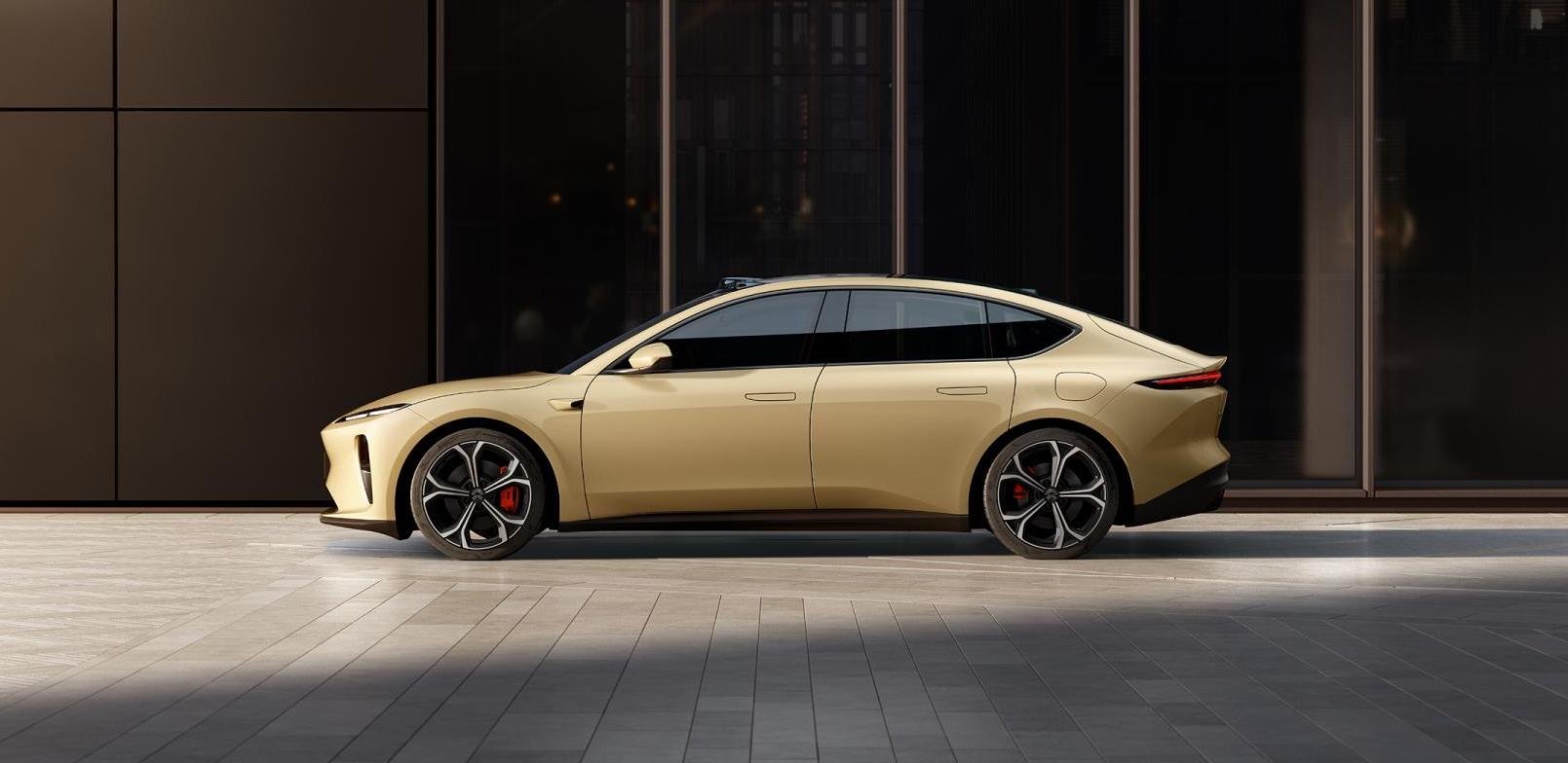 A gold-colored Nio ET5, a midsize electric luxury-sports sedan.
