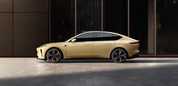 A gold-colored Nio ET5, a midsize electric luxury-sports sedan.