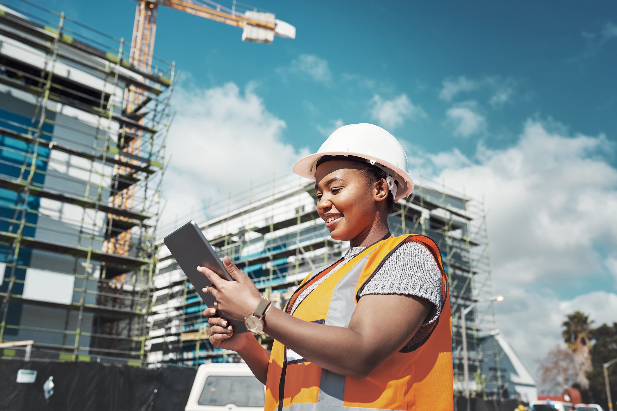 Construction worker using a tablet on a construction site. 