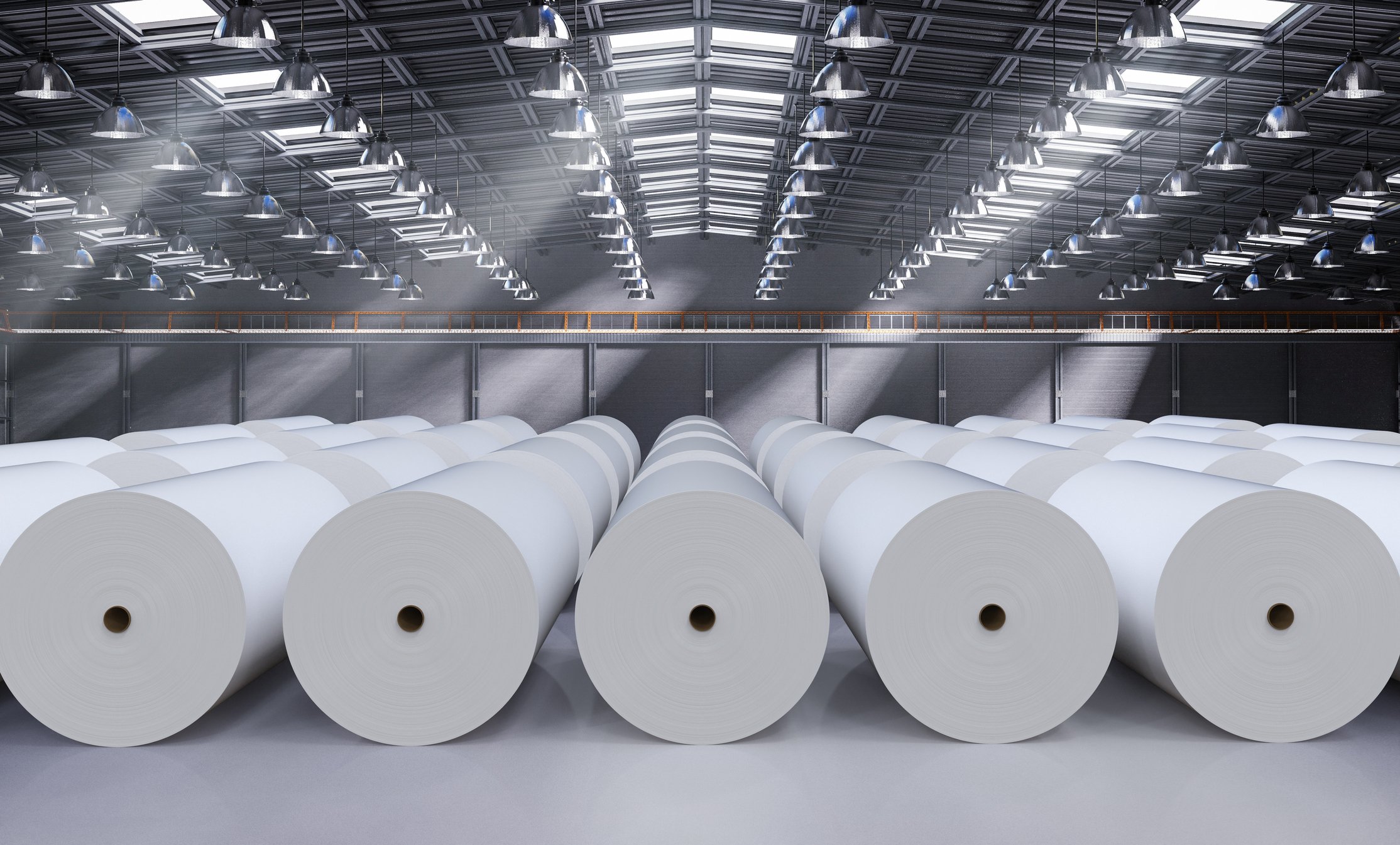 Paper rolls laid out in a warehouse. 