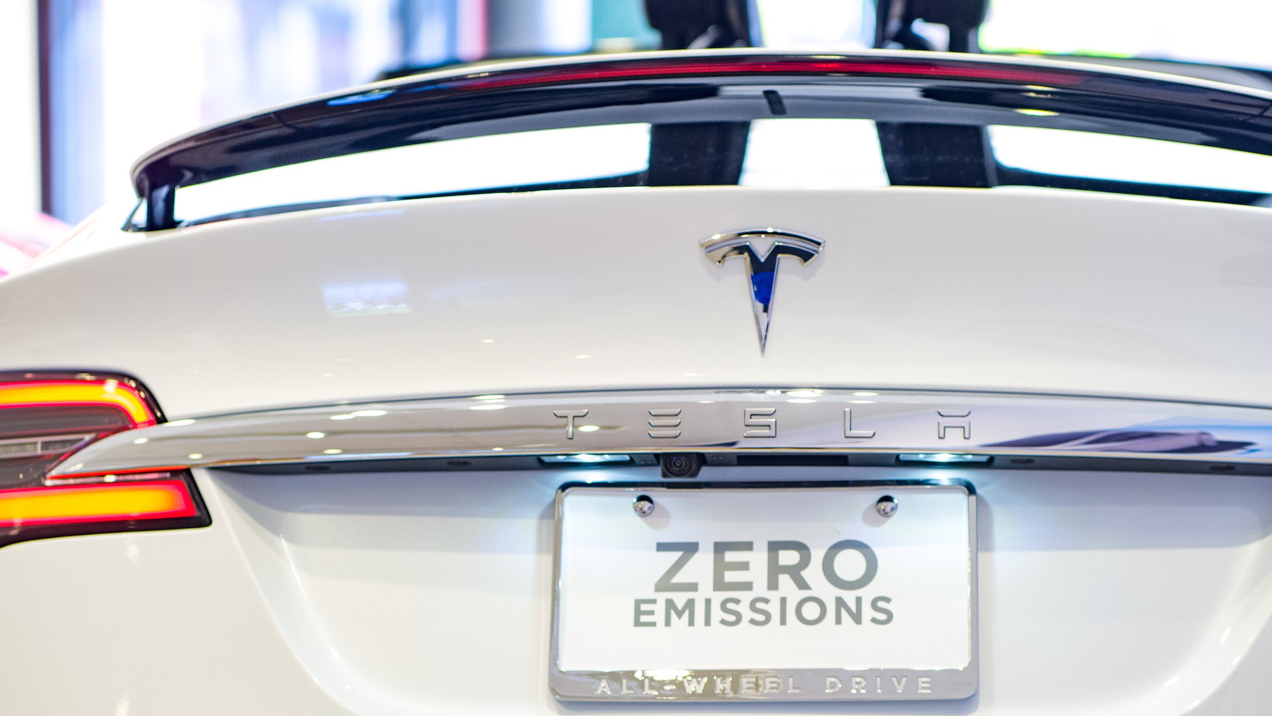 The back of a Tesla vehicle with a license plate reading, Zero Emissions.